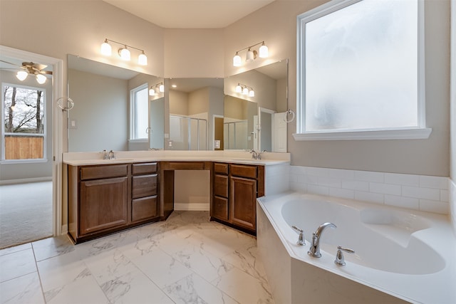 bathroom with a garden tub, vanity, a shower stall, and a healthy amount of sunlight