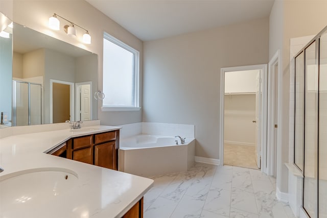 full bath with marble finish floor, vanity, a shower stall, a walk in closet, and a bath