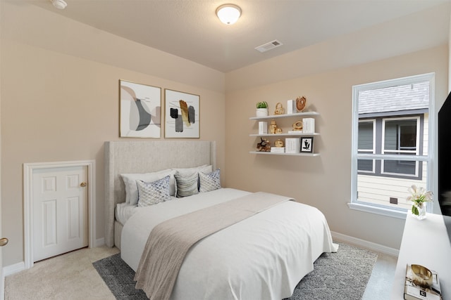 carpeted bedroom with baseboards and visible vents