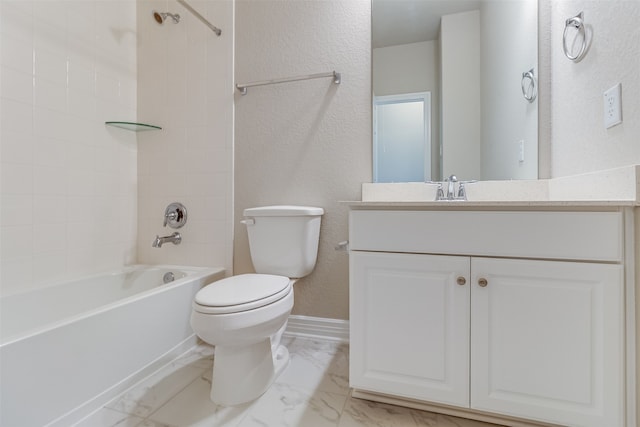bathroom featuring toilet, shower / washtub combination, marble finish floor, vanity, and a textured wall