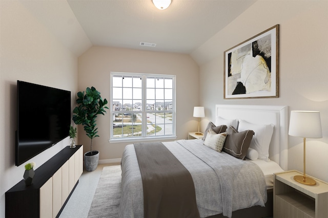 carpeted bedroom featuring lofted ceiling, baseboards, and visible vents