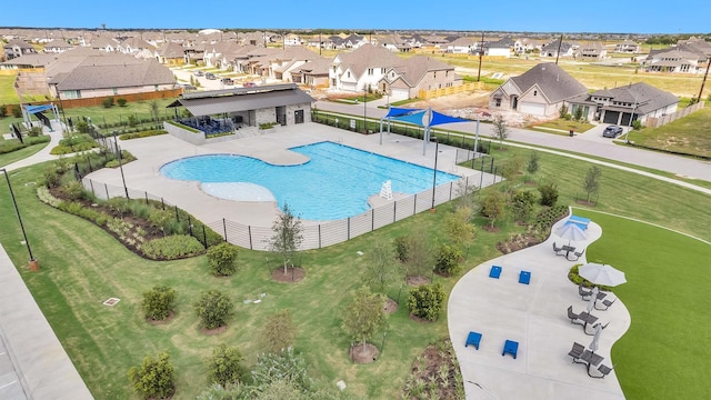 pool with fence and a residential view
