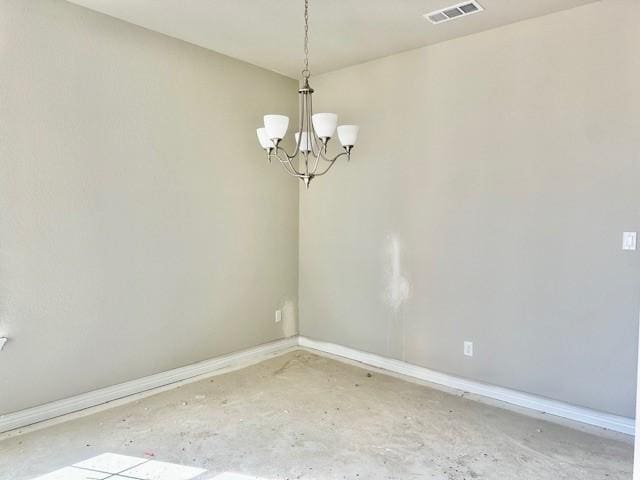 spare room featuring an inviting chandelier, baseboards, visible vents, and concrete floors