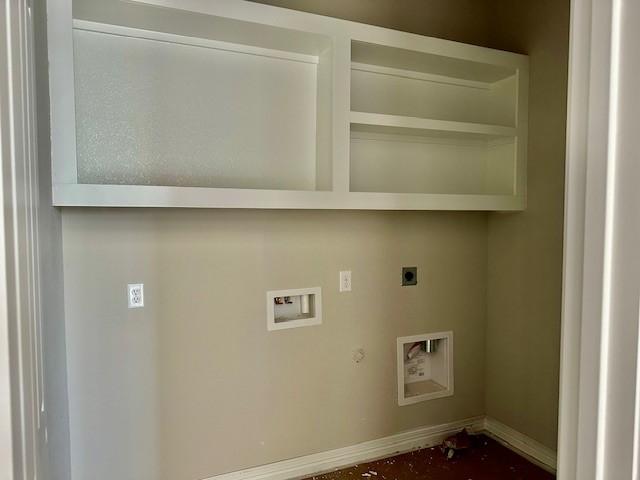 clothes washing area with laundry area, gas dryer hookup, hookup for an electric dryer, hookup for a washing machine, and baseboards