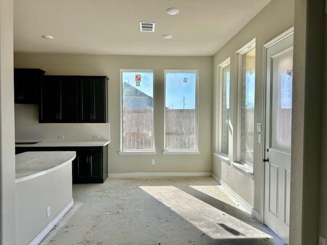 unfurnished dining area featuring baseboards, recessed lighting, and visible vents