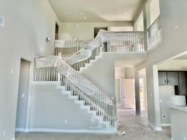 stairway with a towering ceiling