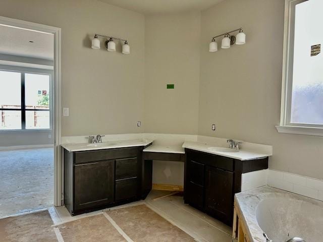 full bath featuring a garden tub and vanity