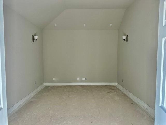 interior space featuring baseboards and lofted ceiling