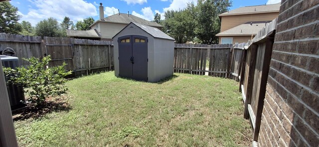 view of yard featuring a storage shed and an outbuilding