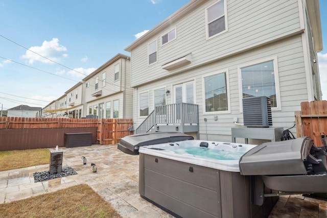 334 Yale Oaks Ln, Houston, TX 77091 - back of property with a hot tub, fence, and a patio area