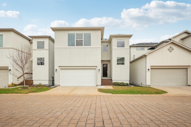334 Yale Oaks Ln, Houston, TX 77091 - view of front facade with decorative driveway, a garage, and stucco siding