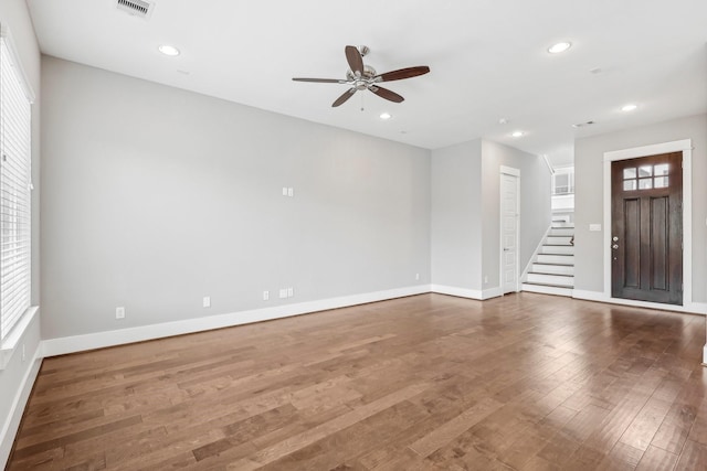 334 Yale Oaks Ln, Houston, TX 77091 - unfurnished living room featuring ceiling fan, stairs, baseboards, wood finished floors, and recessed lighting