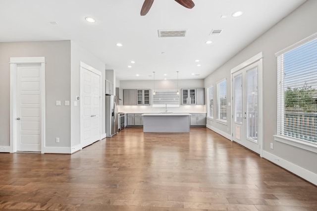 334 Yale Oaks Ln, Houston, TX 77091 - unfurnished living room with ceiling fan, dark wood-type flooring, baseboards, recessed lighting, and a sink