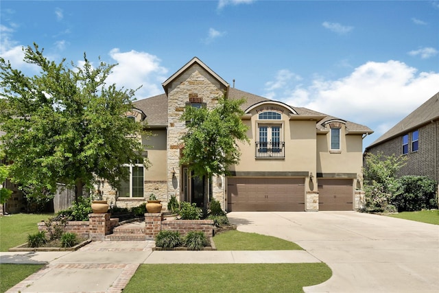 18914 Trinity Star Dr, Cypress, TX 77433 - french country style house featuring stone siding, stucco siding, a garage, and driveway