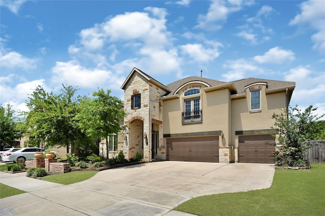 18914 Trinity Star Dr, Cypress, TX 77433 - french country style house with stone siding, a balcony, an attached garage, stucco siding, and concrete driveway