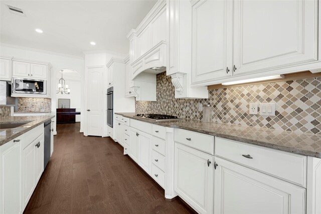 18914 Trinity Star Dr, Cypress, TX 77433 - kitchen with appliances with stainless steel finishes, tasteful backsplash, dark stone counters, white cabinets, and recessed lighting