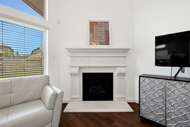 18914 Trinity Star Dr, Cypress, TX 77433 - living area with a fireplace with raised hearth, dark wood-style flooring, healthy amount of natural light, and baseboards