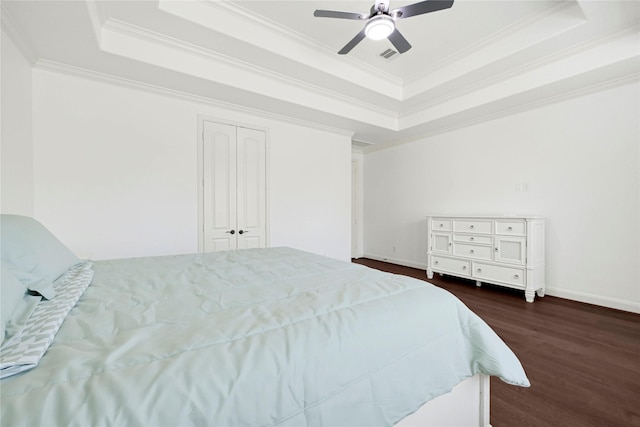 18914 Trinity Star Dr, Cypress, TX 77433 - bedroom with a raised ceiling, crown molding, dark wood finished floors, a ceiling fan, and baseboards