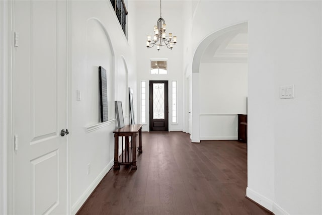 18914 Trinity Star Dr, Cypress, TX 77433 - entrance foyer featuring a chandelier, baseboards, a high ceiling, dark wood finished floors, and arched walkways
