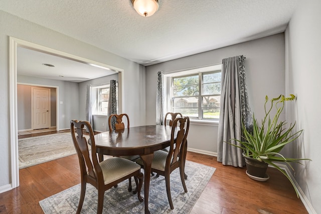 2001 Willow Wisp Dr, Seabrook, TX 77586 - dining space with wood finished floors, baseboards, and a textured ceiling