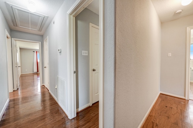 2001 Willow Wisp Dr, Seabrook, TX 77586 - hallway with attic access, wood finished floors, and baseboards
