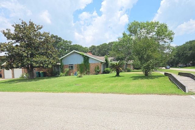 2001 Willow Wisp Dr, Seabrook, TX 77586 - view of home's exterior with brick siding, a chimney, and a lawn