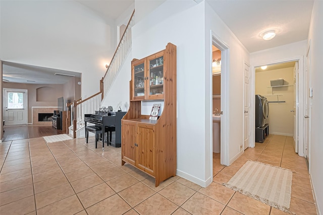 10406 Nickel Grove Dr, Houston, TX 77095 - hallway with light tile patterned flooring, stairway, and baseboards
