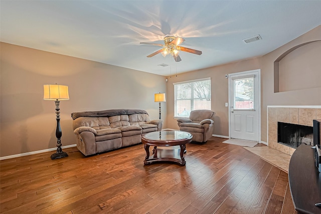 10406 Nickel Grove Dr, Houston, TX 77095 - living area featuring a ceiling fan, wood finished floors, a fireplace, and baseboards