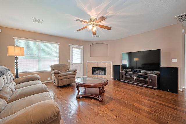 10406 Nickel Grove Dr, Houston, TX 77095 - living area with ceiling fan, hardwood / wood-style flooring, a tiled fireplace, and baseboards