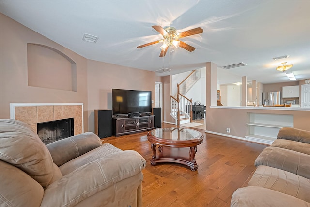 10406 Nickel Grove Dr, Houston, TX 77095 - living area featuring a ceiling fan, hardwood / wood-style floors, stairs, and a fireplace