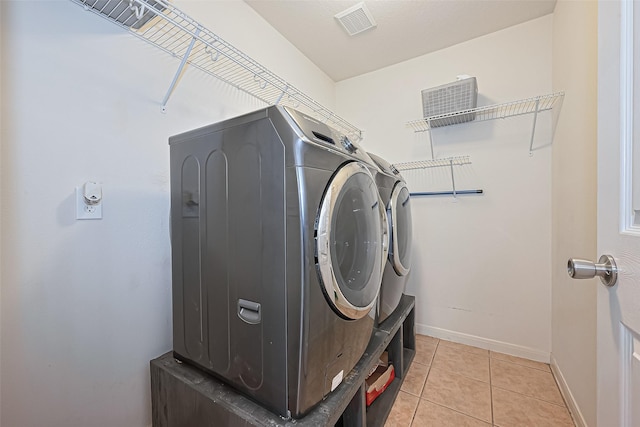 10406 Nickel Grove Dr, Houston, TX 77095 - laundry area featuring washer and dryer, baseboards, and light tile patterned floors