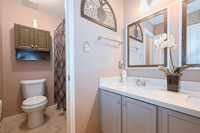 10406 Nickel Grove Dr, Houston, TX 77095 - bathroom with toilet, double vanity, baseboards, and tile patterned flooring