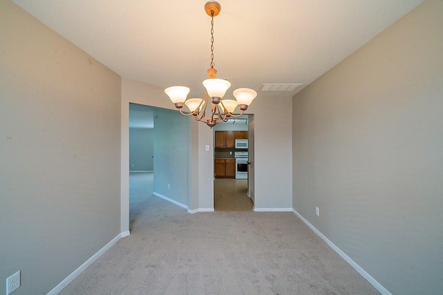 20410 Fall Foliage Dr, Humble, TX 77338 - spare room with baseboards, light carpet, a notable chandelier, and visible vents