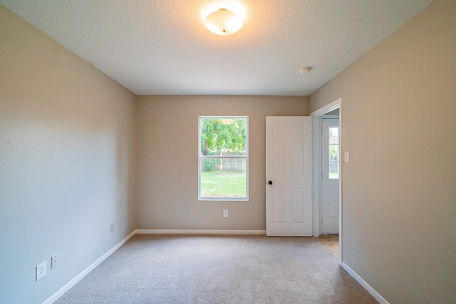20410 Fall Foliage Dr, Humble, TX 77338 - spare room with baseboards, light carpet, and a textured ceiling