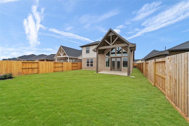 back of property featuring a patio and brick siding