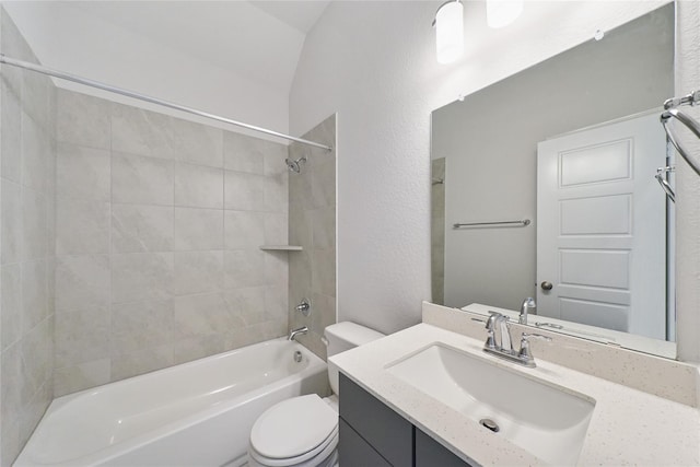 bathroom with toilet, shower / bathtub combination, vanity, lofted ceiling, and a textured wall
