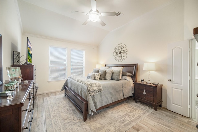 bedroom featuring vaulted ceiling, light wood-style floors, crown molding, and a ceiling fan