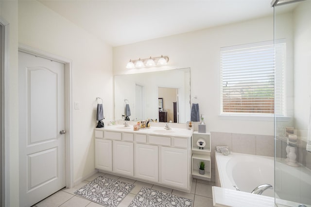 bathroom with tile patterned floors, a garden tub, and double vanity