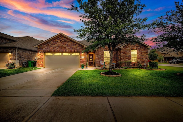 view of front of home featuring brick siding, an attached garage, concrete driveway, and a lawn