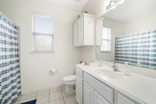 bathroom featuring tile patterned floors, toilet, vanity, baseboards, and a shower with curtain
