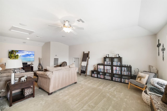 living room with attic access, light carpet, lofted ceiling, and a ceiling fan