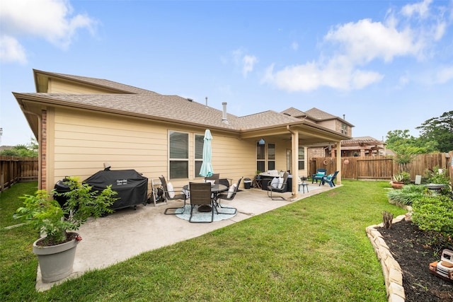 back of property featuring a patio area and a shingled roof