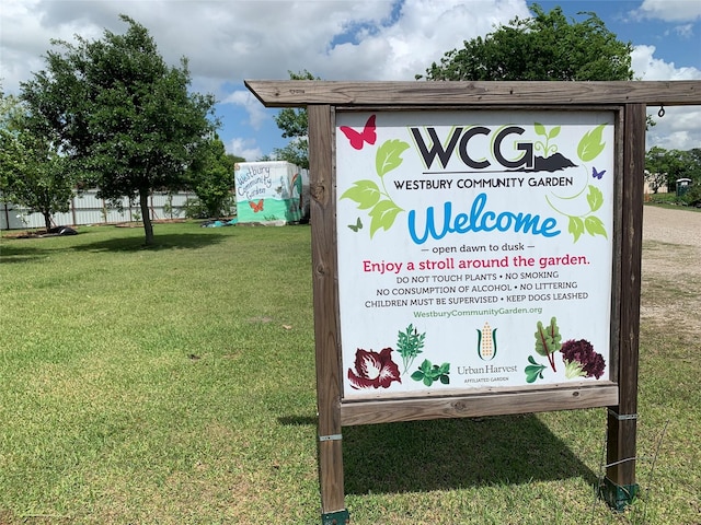 community sign featuring a lawn