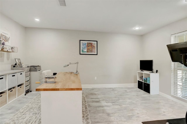 office area featuring light wood-style floors, visible vents, baseboards, and recessed lighting