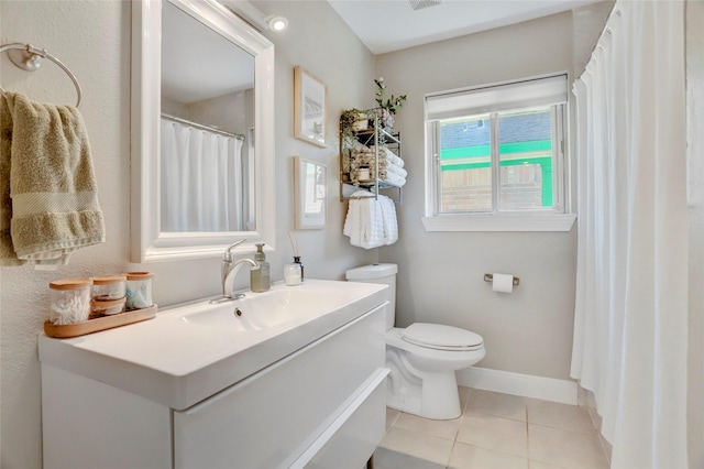 bathroom with toilet, baseboards, tile patterned flooring, and vanity