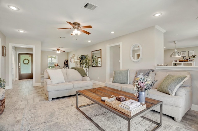 living area featuring a ceiling fan, visible vents, baseboards, light wood-style floors, and recessed lighting
