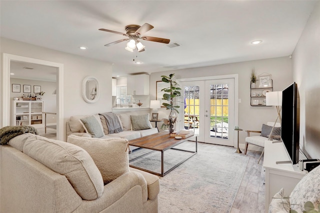 living room with french doors, visible vents, recessed lighting, a ceiling fan, and light wood-style floors