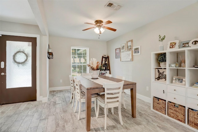 dining area with a ceiling fan, baseboards, light wood-style flooring, and visible vents