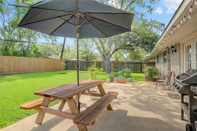 view of patio with a grill, outdoor dining area, and a fenced backyard