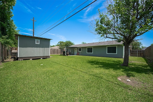 12735 Iroquois St, Houston, TX 77037 - view of yard featuring an outdoor structure, a fenced backyard, and a storage unit